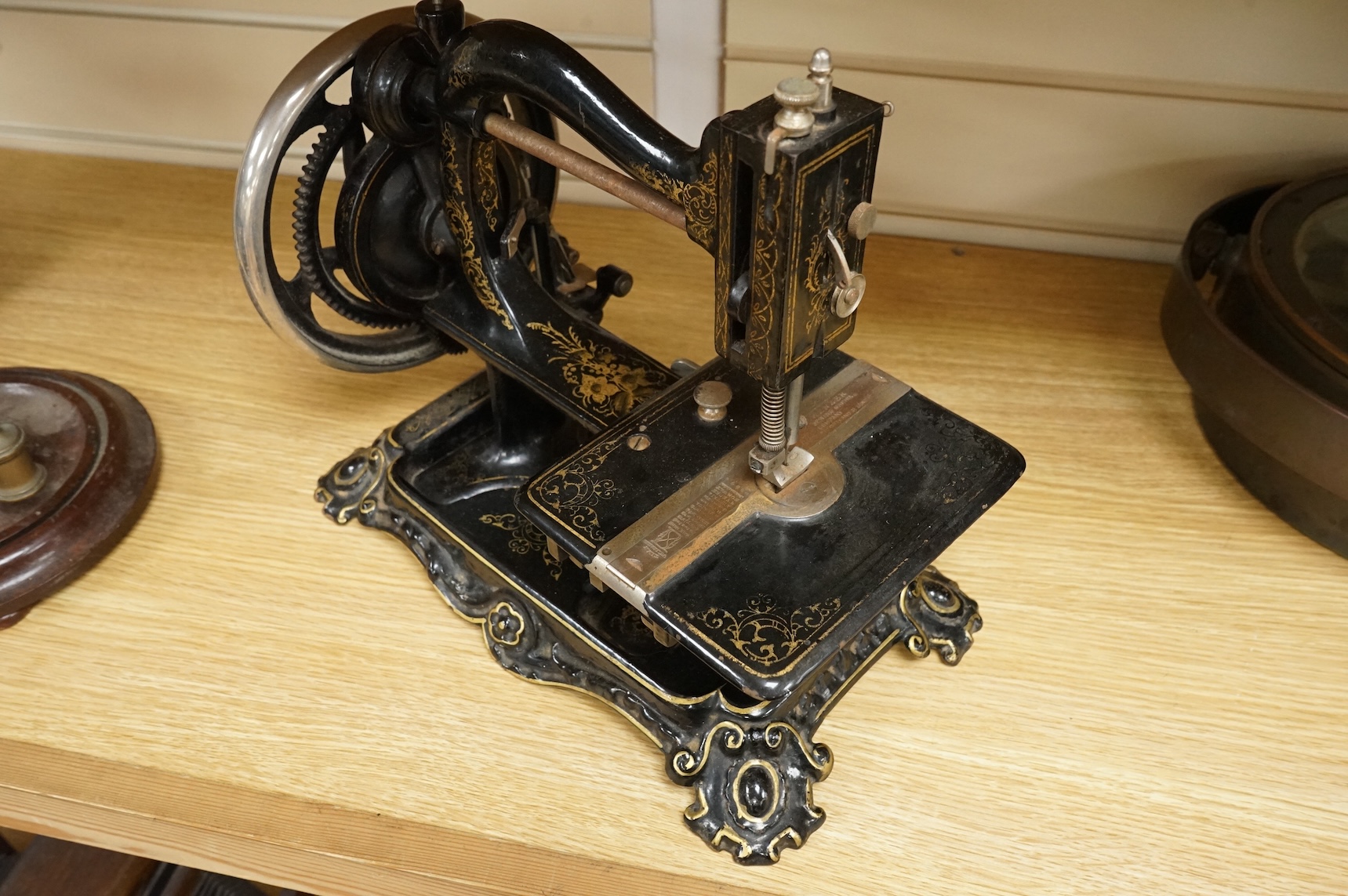 A late 19th century Wanzer sewing machine, in black enamel with gilt decoration.